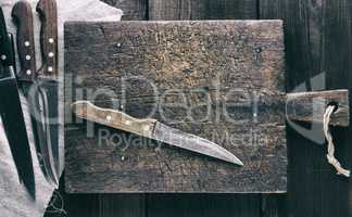 knives and brown wooden cutting board