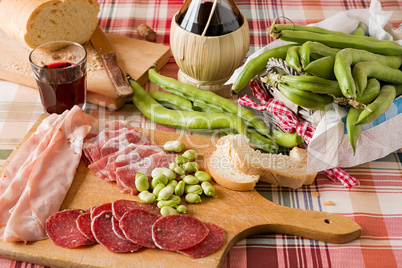 Chopping board of cold meats and broad bean