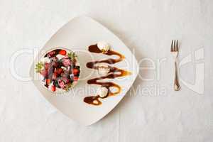 Dessert with strawberries and yogurt in a bowl seen from above