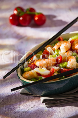 Salad of shrimps and chopsticks