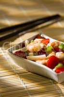 Shrimp salad on a bamboo tablecloth and chopsticks