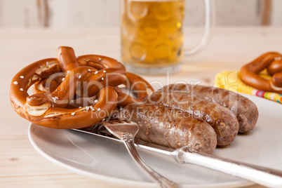 Closeup of bavarian cooked sausage and pretzel