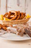 Closeup of bavarian cooked sausage and pretzel