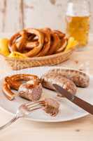 Closeup of bavarian cooked sausage and pretzel