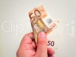 Hand holding a 50 euro banknote