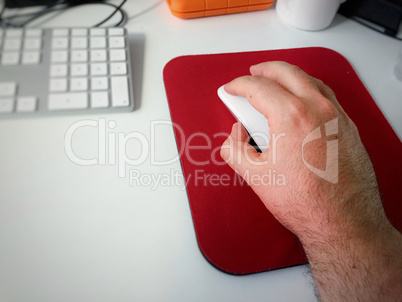 Male hand using a white computer mouse