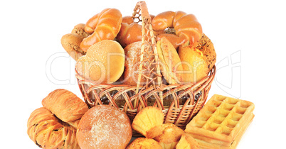Bread and baked goods in a wicker basket isolated on a white bac