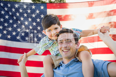 Father with Son Piggy Back Riding In Front of American Flag