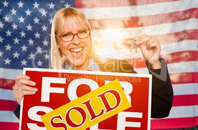 Young Woman Holding House Keys and Sold Sign In Front of America