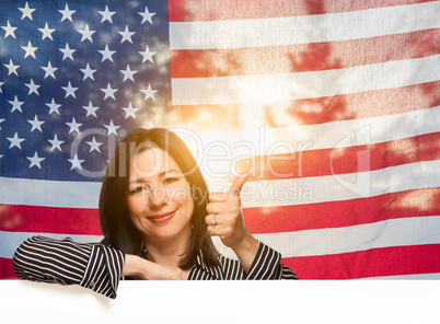 Hispanic Woman With Thumbs Up In Front of American Flag