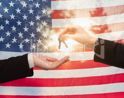 Handing Over House Keys In Front of American Flag
