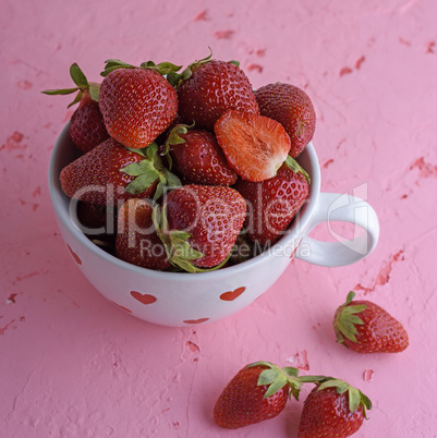 fresh red strawberry in a white ceramic mug