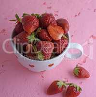 fresh red strawberry in a white ceramic mug