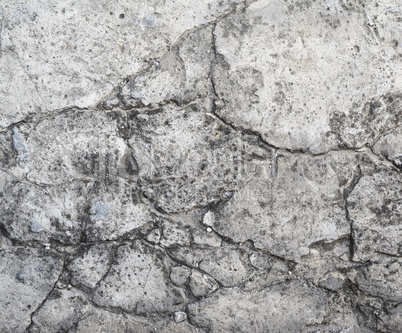 old gray cement wall with cracks