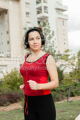 Girl doing sports listening to music on headphones