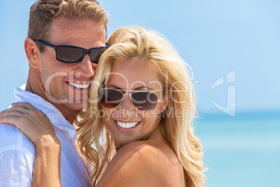 Happy Attractive Woman and Man Couple In Sunglasses At Beach