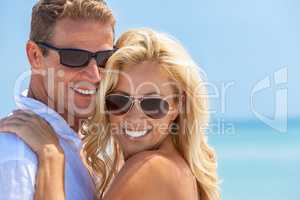 Happy Attractive Woman and Man Couple In Sunglasses At Beach