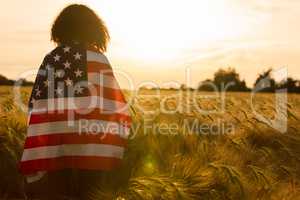 Girl Teenager Wrapped in USA Flag in Field at Sunset