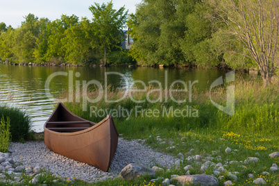 Iron boat near a quiet lake at sunset