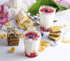 homemade yogurt in transparent glass with syrup and banana