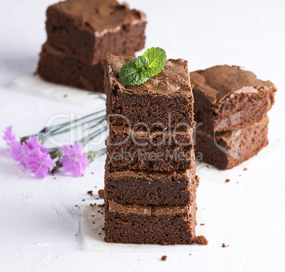 stack of square pieces of baked brown brownie pie