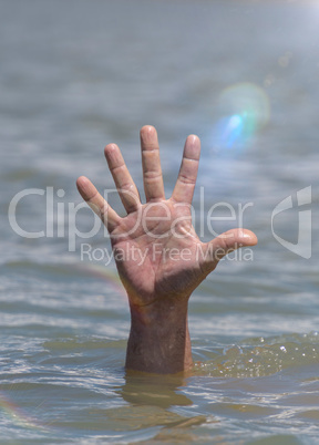 right man's hand sticks out from the water in the middle of the ocean
