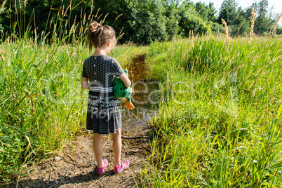 A girl with a toy frog