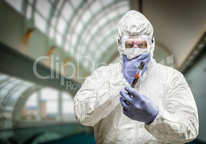 Man Wearing HAZMAT Protective Clothing Holding Test Tube Filled