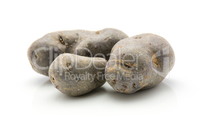 Fresh vitelotte potato isolated on white