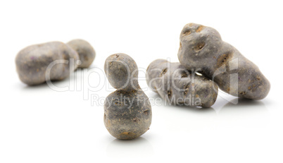 Fresh vitelotte potato isolated on white