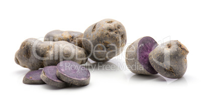 Fresh vitelotte potato isolated on white