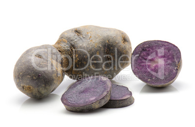 Fresh vitelotte potato isolated on white