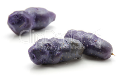 Fresh vitelotte potato isolated on white