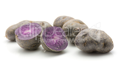 Fresh vitelotte potato isolated on white