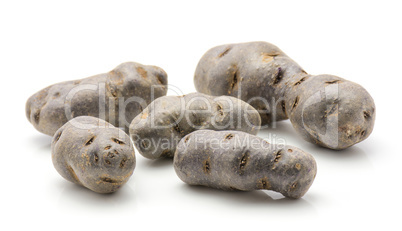 Fresh vitelotte potato isolated on white