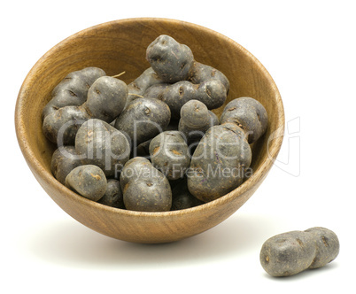 Fresh vitelotte potato isolated on white