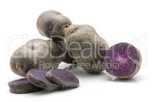 Fresh vitelotte potato isolated on white