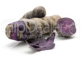 Fresh vitelotte potato isolated on white