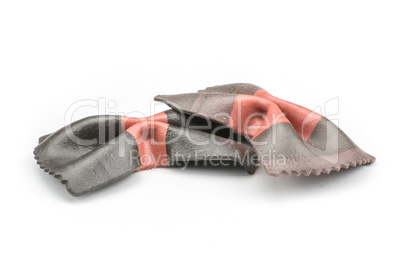 Colourful raw farfalle isolated on white