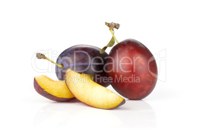 Fresh Raw vibrant plums isolated on white