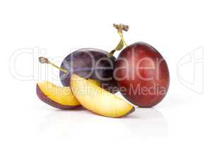 Fresh Raw vibrant plums isolated on white