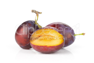 Fresh Raw vibrant plums isolated on white