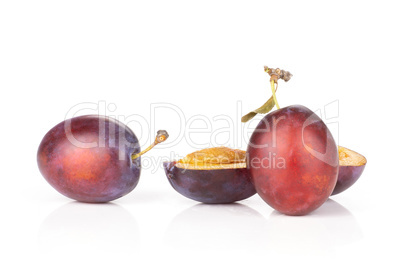 Fresh Raw vibrant plums isolated on white