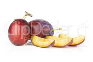 Fresh Raw vibrant plums isolated on white