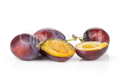 Fresh Raw vibrant plums isolated on white