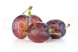 Fresh Raw vibrant plums isolated on white