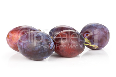 Fresh Raw vibrant plums isolated on white