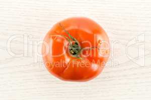Fresh raw Tomato (La Parcela variety) on grey wood