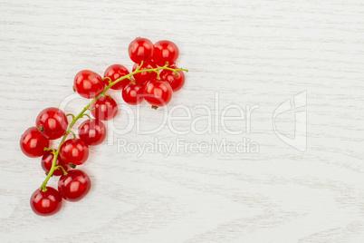 Fresh raw red currant on grey wood