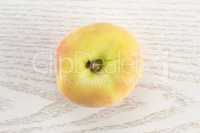 Fresh raw saturn peach on grey wood